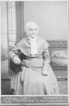 SA0012 - Polly Lewis was from the South Family. A studio portrait, she is seated in a chair. Caption on the back: "The soul of the South Family".